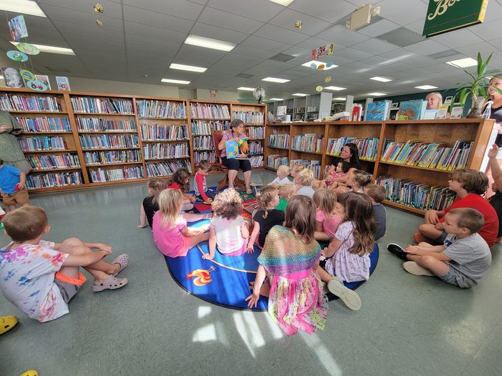 Ms. Joann reading to a group of kids.